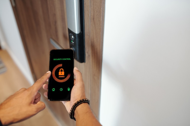 Man standing at entrance door and using smart lock application